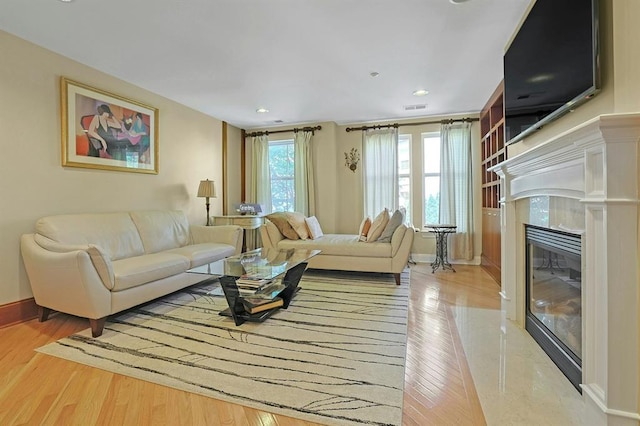 27 Bridge Ln, Haverstraw, NY 10927 - living room featuring wood finished floors, a high end fireplace, and recessed lighting