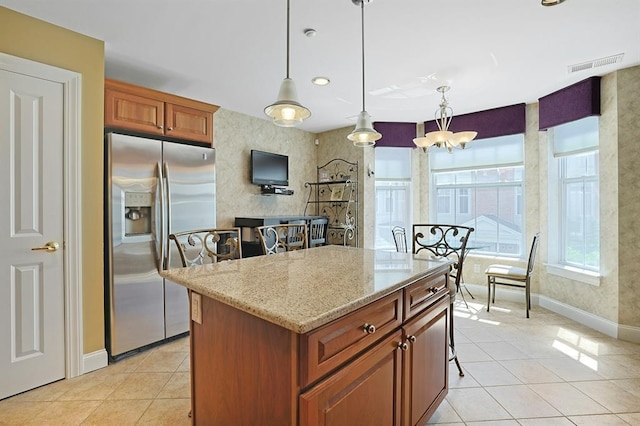27 Bridge Ln, Haverstraw, NY 10927 - kitchen featuring stainless steel refrigerator with ice dispenser, light tile patterned floors, light stone counters, hanging light fixtures, and recessed lighting