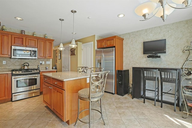 27 Bridge Ln, Haverstraw, NY 10927 - kitchen with appliances with stainless steel finishes, tasteful backsplash, light stone countertops, a center island, and light tile patterned floors