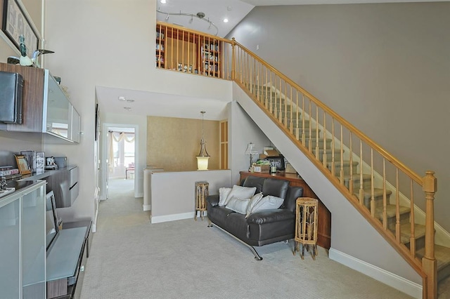 27 Bridge Ln, Haverstraw, NY 10927 - carpeted living room with stairway, a towering ceiling, and recessed lighting
