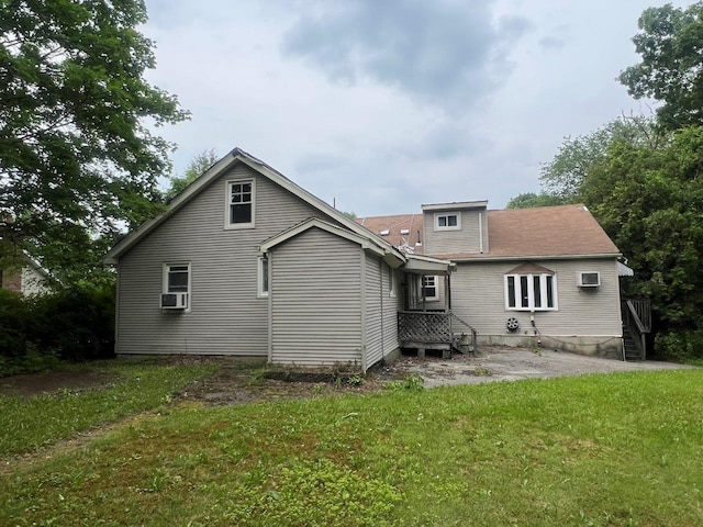 16 Bethlehem Pl, Poughkeepsie, NY 12603 - rear view of house featuring a lawn, cooling unit, and a patio area
