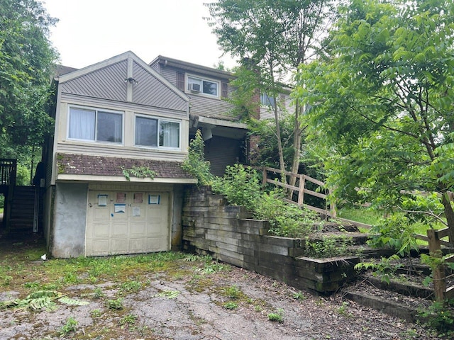 16 Bethlehem Pl, Poughkeepsie, NY 12603 - back of house featuring an attached garage, stairway, and driveway