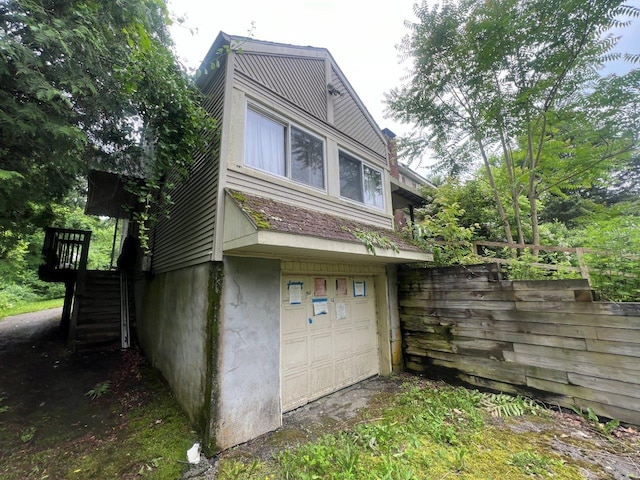 16 Bethlehem Pl, Poughkeepsie, NY 12603 - view of side of property with stairs and an attached garage