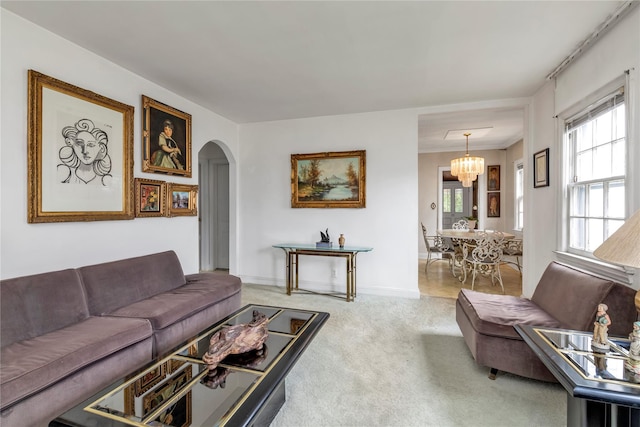68 Moore St, New Hyde Park, NY 11040 - carpeted living room featuring a chandelier and arched walkways
