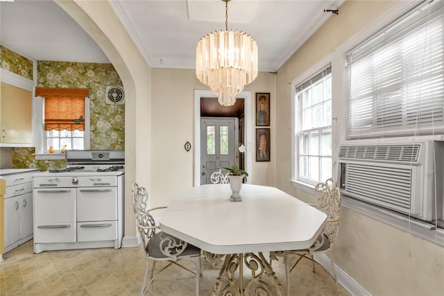 68 Moore St, New Hyde Park, NY 11040 - dining area with arched walkways, a chandelier, wallpapered walls, crown molding, and cooling unit