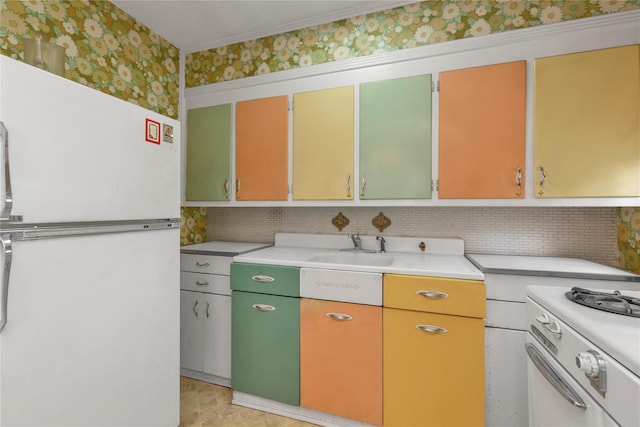 68 Moore St, New Hyde Park, NY 11040 - kitchen featuring white appliances, wallpapered walls, light countertops, and backsplash
