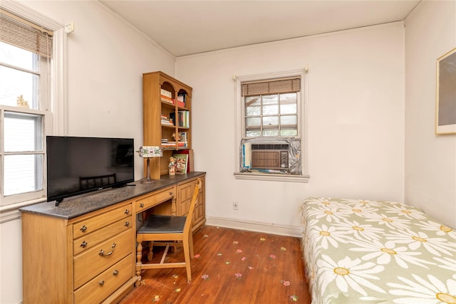 68 Moore St, New Hyde Park, NY 11040 - bedroom with dark wood finished floors, cooling unit, ornamental molding, and built in desk