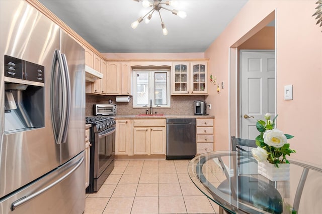 91-23 156th Ave, Howard Beach, NY 11414 - kitchen featuring appliances with stainless steel finishes, light brown cabinets, a chandelier, light countertops, and light tile patterned floors