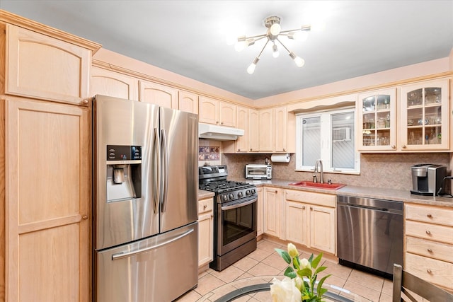 91-23 156th Ave, Howard Beach, NY 11414 - kitchen featuring stainless steel appliances, under cabinet range hood, light brown cabinets, a chandelier, and light tile patterned flooring