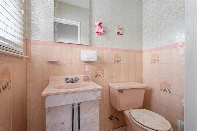 91-23 156th Ave, Howard Beach, NY 11414 - bathroom featuring wallpapered walls, tile walls, and a wainscoted wall