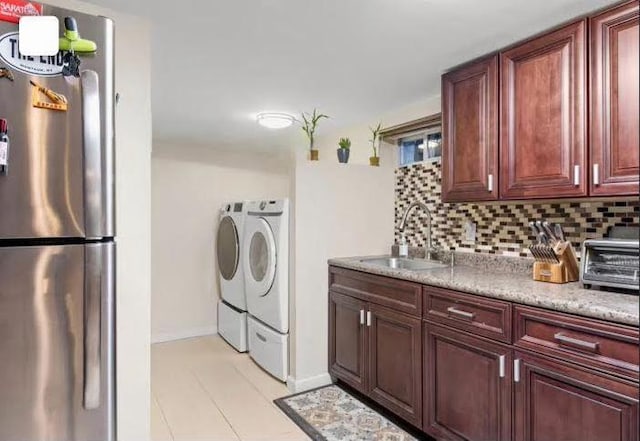 91-23 156th Ave, Howard Beach, NY 11414 - kitchen featuring freestanding refrigerator, independent washer and dryer, light tile patterned floors, and backsplash