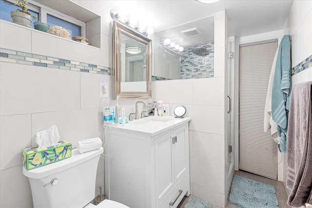 91-23 156th Ave, Howard Beach, NY 11414 - bathroom featuring tile walls, vanity, an enclosed shower, and wood finished floors