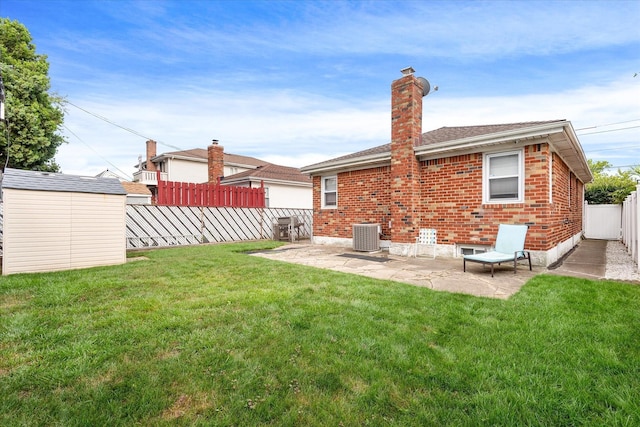 91-23 156th Ave, Howard Beach, NY 11414 - back of property with a patio, brick siding, a fenced backyard, and a shed