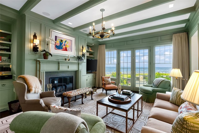 59 Shore Rd, Westhampton, NY 11977 - living area with a chandelier, a glass covered fireplace, beam ceiling, and built in features