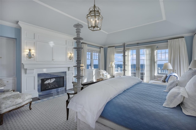 59 Shore Rd, Westhampton, NY 11977 - bedroom with multiple windows, a fireplace, french doors, access to exterior, and ornamental molding