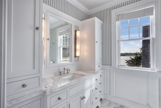 59 Shore Rd, Westhampton, NY 11977 - bathroom with vanity, healthy amount of natural light, marble look tiles, ornamental molding, and wainscoting