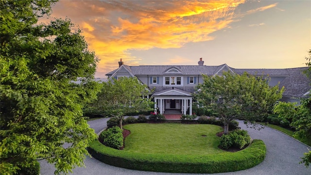 59 Shore Rd, Westhampton, NY 11977 - view of front facade with a front yard and a chimney