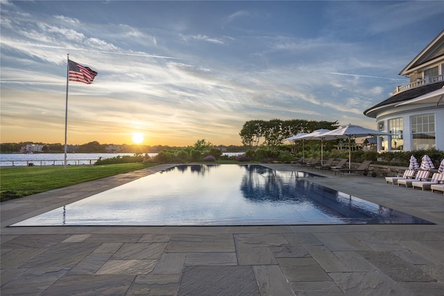 59 Shore Rd, Westhampton, NY 11977 - pool at dusk with a patio, an infinity pool, and a water view