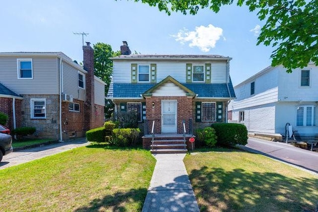 7318 180th St, Fresh Meadows, NY 11366 - traditional-style home with a front yard, brick siding, and a chimney