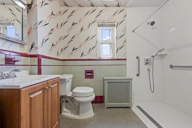 7318 180th St, Fresh Meadows, NY 11366 - full bathroom with wallpapered walls, a shower, vanity, tile patterned floors, and tile walls