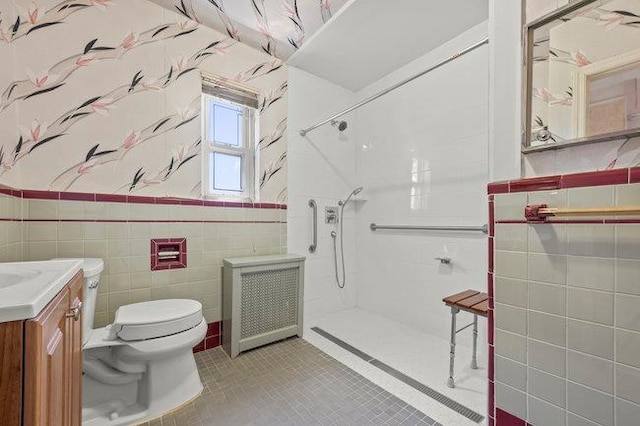 7318 180th St, Fresh Meadows, NY 11366 - full bath featuring radiator, tile walls, a walk in shower, vanity, and tile patterned flooring