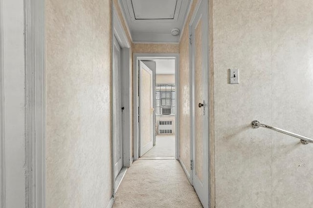 7318 180th St, Fresh Meadows, NY 11366 - corridor featuring radiator heating unit, light colored carpet, and a textured wall