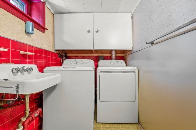7318 180th St, Fresh Meadows, NY 11366 - laundry area featuring cabinet space, tile walls, tile patterned floors, and separate washer and dryer