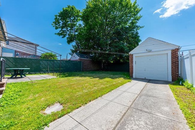 7318 180th St, Fresh Meadows, NY 11366 - view of yard with an outdoor structure, a detached garage, and concrete driveway