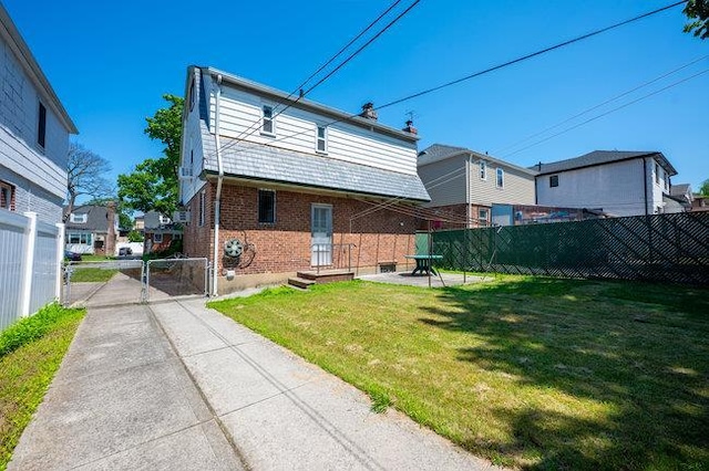 7318 180th St, Fresh Meadows, NY 11366 - rear view of property featuring brick siding, a gate, concrete driveway, and entry steps