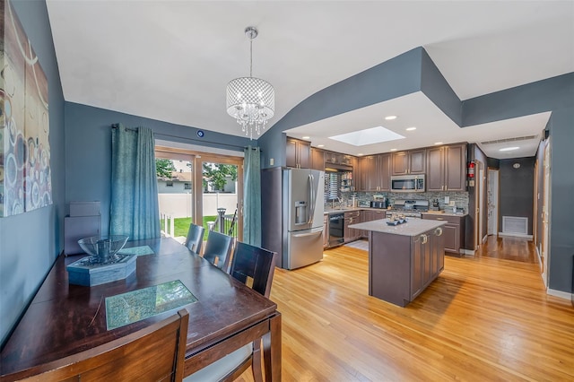 41 W 21st St, Deer Park, NY 11729 - kitchen featuring appliances with stainless steel finishes, a chandelier, light wood finished floors, light countertops, and backsplash