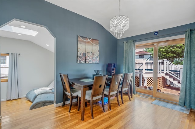 41 W 21st St, Deer Park, NY 11729 - dining room featuring vaulted ceiling, wood finished floors, a chandelier, recessed lighting, and a skylight