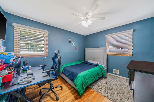 41 W 21st St, Deer Park, NY 11729 - bedroom with wood finished floors, a ceiling fan, and an office area