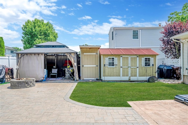 41 W 21st St, Deer Park, NY 11729 - back of property with a fire pit, a patio area, a gazebo, and a shed