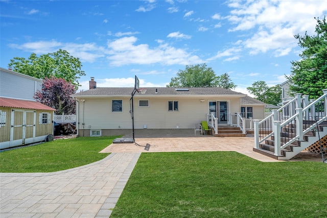 41 W 21st St, Deer Park, NY 11729 - rear view of house featuring a patio area, a storage unit, a lawn, a chimney, and stairway