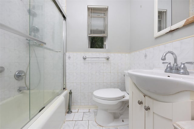 75-06A 255th St Unit A, Glen Oaks, NY 11004 - full bathroom with vanity, tile walls, combined bath / shower with glass door, and a wainscoted wall