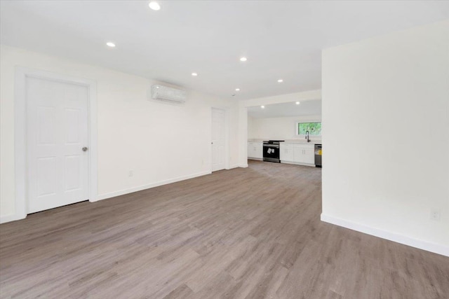 8 Pioneer Trl, Monroe, NY 10950 - unfurnished living room featuring a wall unit AC, light wood-type flooring, and recessed lighting