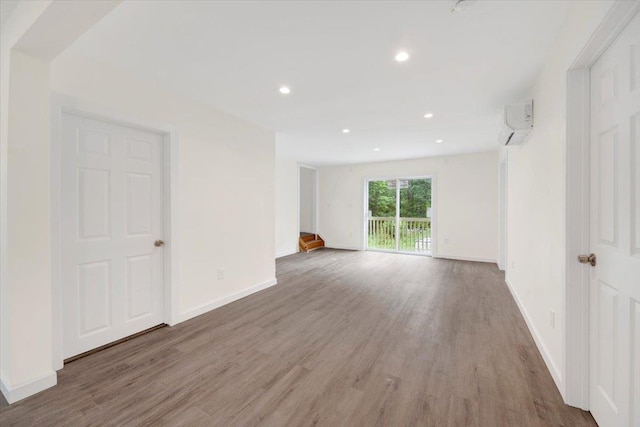 8 Pioneer Trl, Monroe, NY 10950 - spare room with wood finished floors, recessed lighting, and a wall unit AC