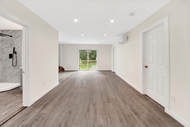 8 Pioneer Trl, Monroe, NY 10950 - spare room featuring a wall unit AC, wood finished floors, a smoke detector, and recessed lighting