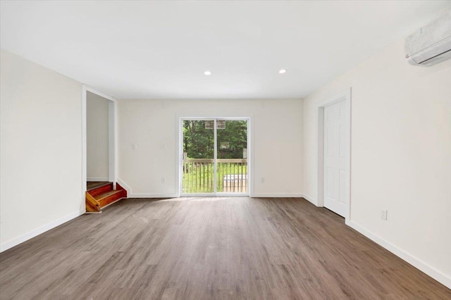 8 Pioneer Trl, Monroe, NY 10950 - unfurnished living room featuring a wall mounted air conditioner, wood finished floors, and recessed lighting