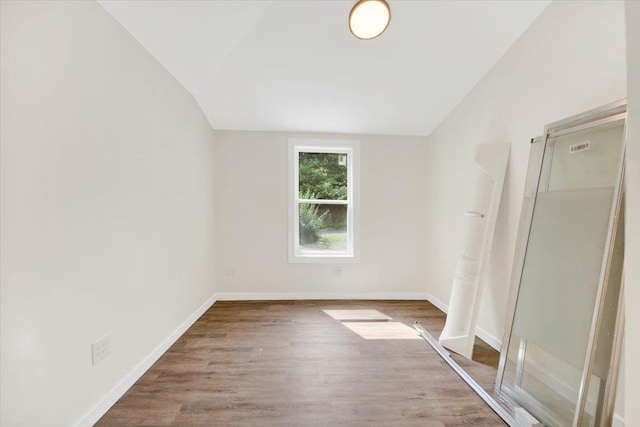 8 Pioneer Trl, Monroe, NY 10950 - unfurnished bedroom with lofted ceiling and wood finished floors