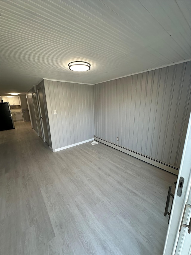 833 Bermuda Rd, West Babylon, NY 11704 - unfurnished room with baseboard heating and light wood finished floors
