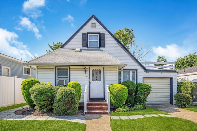 245 E Seaman Ave, Freeport, NY 11520 - view of front of home with a garage, concrete driveway, and cooling unit