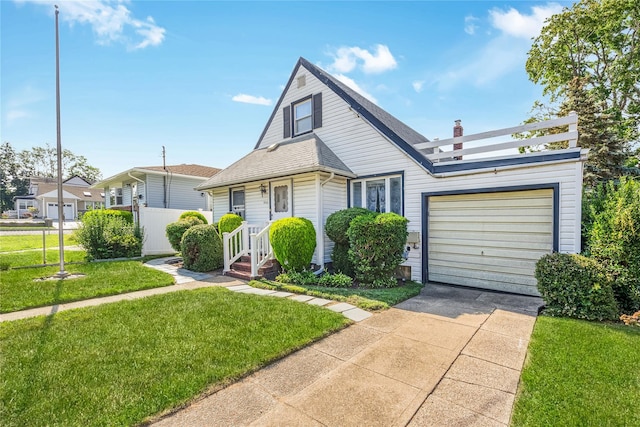 245 E Seaman Ave, Freeport, NY 11520 - bungalow featuring driveway, a garage, and a front lawn