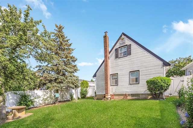 245 E Seaman Ave, Freeport, NY 11520 - back of house featuring a chimney and a fenced backyard