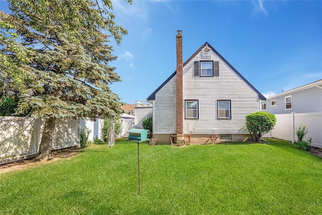 245 E Seaman Ave, Freeport, NY 11520 - rear view of house with a chimney and a fenced backyard