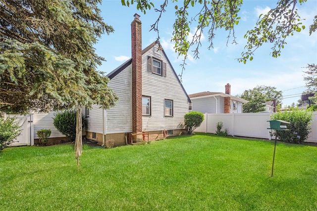 245 E Seaman Ave, Freeport, NY 11520 - back of house featuring a fenced backyard and a chimney
