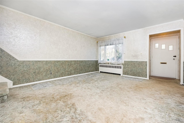 245 E Seaman Ave, Freeport, NY 11520 - carpeted foyer entrance with radiator, ornamental molding, and wallpapered walls