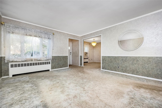 245 E Seaman Ave, Freeport, NY 11520 - carpeted empty room featuring radiator, wallpapered walls, crown molding, and wainscoting