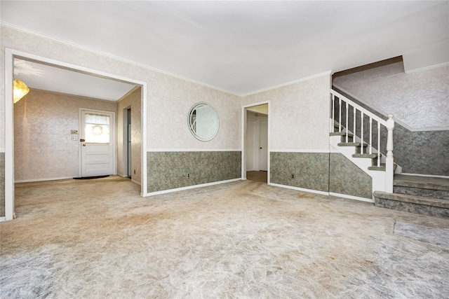 245 E Seaman Ave, Freeport, NY 11520 - unfurnished living room featuring wallpapered walls, carpet floors, crown molding, and stairs