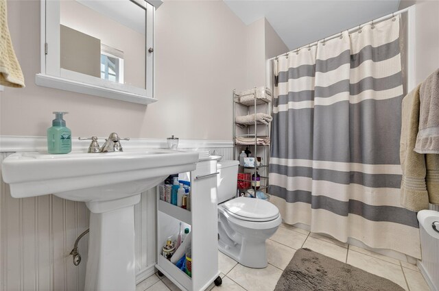 3 Stanford Dr, Highland Mills, NY 10930 - bathroom featuring tile patterned floors, a wainscoted wall, a shower with shower curtain, and radiator